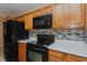 Stainless steel appliances and wood cabinetry create a modern kitchen space at 101 Kingston Ln, Graham, NC 27253