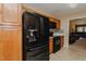 Kitchen with oak cabinets, black appliances, tile backsplash, and black smooth-top range at 101 Kingston Ln, Graham, NC 27253