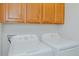 Well-lit laundry room features a new white washer and dryer at 101 Kingston Ln, Graham, NC 27253