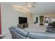Open living room with a vaulted ceiling, ceiling fan, and neutral walls and carpets at 101 Kingston Ln, Graham, NC 27253