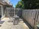 Cozy patio with charming metal table and chairs, and a wooden fence with string lights for ambiance at 101 Kingston Ln, Graham, NC 27253