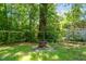Backyard fire pit area surrounded by lush greenery and a wooden fence, creating a relaxing outdoor space at 1022 Carolina Ave, Durham, NC 27705