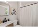 Cozy bathroom featuring a modern vanity, stylish mirror, and a shower with a classic white shower curtain at 1022 Carolina Ave, Durham, NC 27705