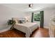 Comfortable bedroom with hardwood floors, ceiling fan, natural light, and decorative accents at 1022 Carolina Ave, Durham, NC 27705