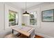 Dining area features windows offering views and a stylish pendant light above the table at 1022 Carolina Ave, Durham, NC 27705