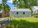 Rear exterior featuring a well-maintained yard, fence, and the back of the home at 1022 Carolina Ave, Durham, NC 27705