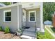 Inviting front entrance of a grey home with a small porch and brick steps at 1022 Carolina Ave, Durham, NC 27705