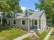 Charming grey home featuring a well-manicured lawn, dormers, and sidewalk entrance at 1022 Carolina Ave, Durham, NC 27705