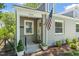 Charming home exterior with a gray brick facade, an American flag, and manicured landscaping at 1022 Carolina Ave, Durham, NC 27705