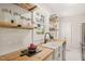 Bright kitchen with white subway tile backsplash, butcher block counters and open shelving at 1022 Carolina Ave, Durham, NC 27705