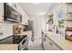 Bright, renovated kitchen featuring butcher block countertops, stainless steel appliances, and ample storage at 1022 Carolina Ave, Durham, NC 27705