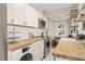 Modern kitchen features white cabinets, stainless steel appliances, and butcher block countertops at 1022 Carolina Ave, Durham, NC 27705
