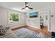 Bright living room features hardwood floors, ceiling fan, and a large window for natural light at 1022 Carolina Ave, Durham, NC 27705