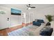 Cozy living room with hardwood floors, ceiling fan and blue accent furniture at 1022 Carolina Ave, Durham, NC 27705