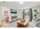 Cozy living room featuring hardwood floors, a plush rug, and an abundance of natural light at 1022 Carolina Ave, Durham, NC 27705