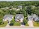 An aerial view shows a neighborhood with mature trees and well-maintained homes and lawns at 103 Equestrian Ct, Cary, NC 27513
