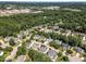 Overhead image of the area with a mix of residential and commercial buildings surrounded by verdant trees and landscaping at 103 Equestrian Ct, Cary, NC 27513