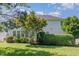 Back yard features a lush green lawn, mature trees, shrubs, and the rear of the house at 103 Equestrian Ct, Cary, NC 27513