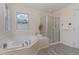 Relaxing bathroom featuring a soaking tub and walk-in shower at 103 Equestrian Ct, Cary, NC 27513