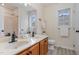 Bright bathroom with double sinks, vinyl flooring, and lots of natural light at 103 Equestrian Ct, Cary, NC 27513