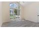 Sun-filled bedroom with a large window, neutral walls, and light wood-look floors, creating a serene and inviting space at 103 Equestrian Ct, Cary, NC 27513