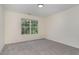Bedroom with neutral paint, gray carpet and a window that provides natural light at 103 Equestrian Ct, Cary, NC 27513