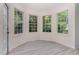 Bright breakfast nook surrounded by large windows offering serene views of the outdoors and plenty of natural light at 103 Equestrian Ct, Cary, NC 27513