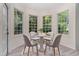 Sun-filled breakfast nook with many large windows and an intimate table setting, perfect for enjoying morning meals at 103 Equestrian Ct, Cary, NC 27513