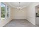 Open dining area with a light fixture above, and lots of light from a large picture window at 103 Equestrian Ct, Cary, NC 27513