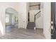 Grand foyer showcasing an open staircase, light wood-look flooring, and an open doorway to the dining room at 103 Equestrian Ct, Cary, NC 27513