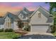 Charming two-story traditional home featuring a manicured lawn, attached garage, and welcoming entrance with brick steps at 103 Equestrian Ct, Cary, NC 27513