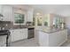 Open kitchen design with granite countertops, light-colored flooring, and a bright window at 103 Equestrian Ct, Cary, NC 27513