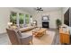 Comfortable living room with a cozy fireplace, plush seating, and large windows for natural light, ideal for relaxation at 103 Equestrian Ct, Cary, NC 27513