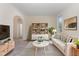 Cozy living room features a white sofa, decorative bookcase, and striped rug for added charm at 103 Equestrian Ct, Cary, NC 27513