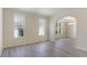 Bright room with large windows, neutral walls, light-colored flooring, and a view to the dining area at 103 Equestrian Ct, Cary, NC 27513