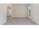 An open living room features an archway, neutral walls, light-colored flooring, and a bright window at 103 Equestrian Ct, Cary, NC 27513