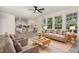Inviting living room with neutral tones, large windows, and open access to the kitchen and dining area for easy flow at 103 Equestrian Ct, Cary, NC 27513