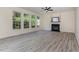 Spacious living room with a fireplace, large windows offering ample natural light, and a view of the backyard at 103 Equestrian Ct, Cary, NC 27513