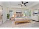 Spacious main bedroom featuring a ceiling fan, a rug, and multiple windows providing ample natural light at 103 Equestrian Ct, Cary, NC 27513