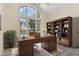 Bright home office featuring a large window, vaulted ceilings, a stylish desk, and a well-appointed bookcase at 103 Equestrian Ct, Cary, NC 27513