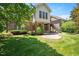 Manicured backyard with lush green grass, a patio, and exterior stairs leading up to a deck at 107 Sonoma Valley Dr, Cary, NC 27518