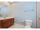 Bathroom featuring a vanity with cherry wood cabinets, a large mirror, and tile floors at 107 Sonoma Valley Dr, Cary, NC 27518