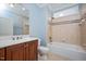 Well-lit bathroom with a large mirror, cherry wood cabinets, and separate shower/tub at 107 Sonoma Valley Dr, Cary, NC 27518