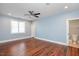 Bedroom featuring hardwood floors, a ceiling fan, and access to an ensuite bathroom at 107 Sonoma Valley Dr, Cary, NC 27518