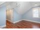 Bedroom featuring hardwood floors, a window, and a slanted ceiling at 107 Sonoma Valley Dr, Cary, NC 27518