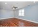 Spacious bedroom featuring hardwood floors, a ceiling fan, and a window at 107 Sonoma Valley Dr, Cary, NC 27518
