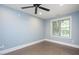 Bedroom with neutral walls, ceiling fan, a window bringing in natural light, and stained concrete floors at 107 Sonoma Valley Dr, Cary, NC 27518