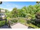 Private deck overlooking a verdant lawn with mature trees providing natural shade and beauty at 107 Sonoma Valley Dr, Cary, NC 27518