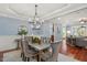 Open concept dining and living area features wood floors and natural light at 107 Sonoma Valley Dr, Cary, NC 27518