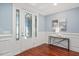 Elegant foyer with a decorative glass front door, hardwood floors, and wainscoting at 107 Sonoma Valley Dr, Cary, NC 27518